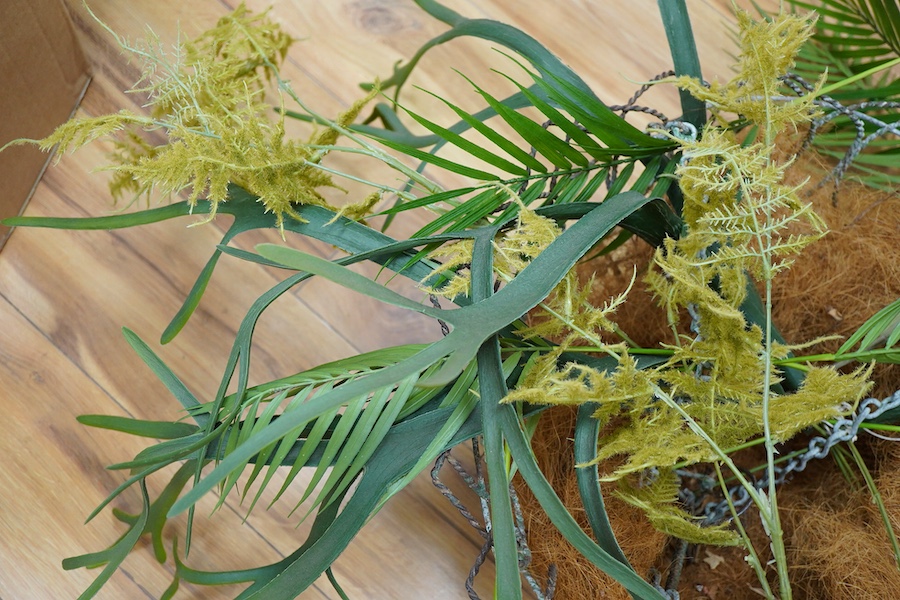 A large wire work hanging basket and decorative faux foliage, 50cm wide